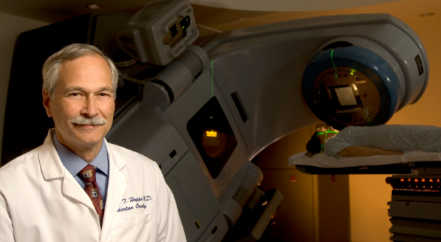 Richard Hoppe, MD, professor of radiation oncology, with a modern medical linear accelerator