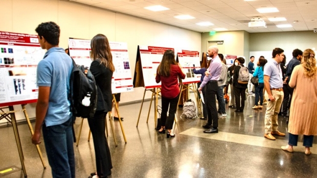 students viewing poster presentations