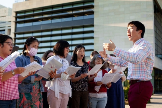 School of Medicine Chorus Director Minseung Choi leads a rehersal outside of LKSC, 2022.