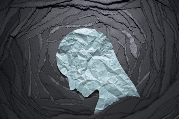 Grey paper head on black backtround - photo from Adobe Stock Images