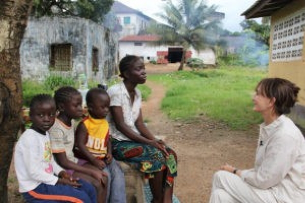 Photo of Nancy Snyderman with childran and a young woman in Liberia