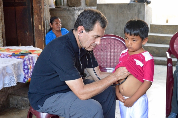 Physician examining a Guatemalan boy