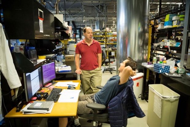Stephen Quake talking to a researcher in his lab