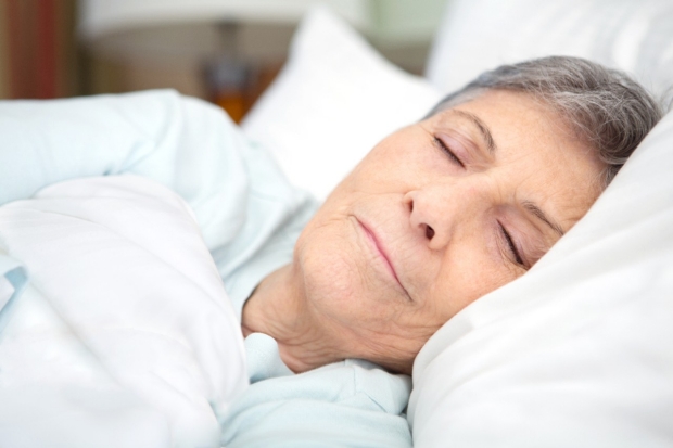 Older woman asleep in a bed