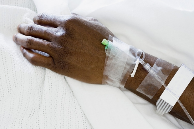 patient's hand attached to IV drip