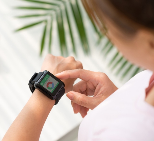woman looking at smartwatch on her wrist