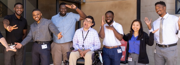 A group of Stanford HBMC community members strike funny poses on Stanford campus